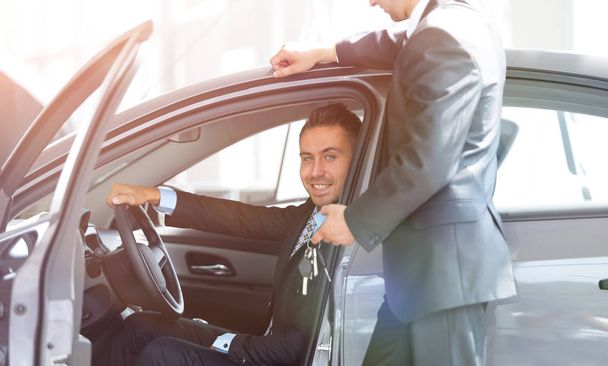 successful businessman, receiving the keys to the car from the s - 写真・画像