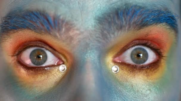 Close-up of male eyes in makeup. The actor portrays fear or suspicion. - Felvétel, videó