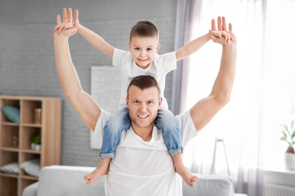Happy dad playing with his son at home. Father's day celebration - Fotoğraf, Görsel