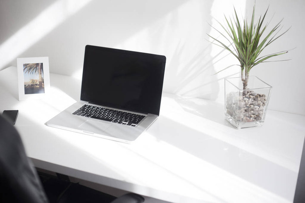 Laptop on the white desk with white background - Photo, Image