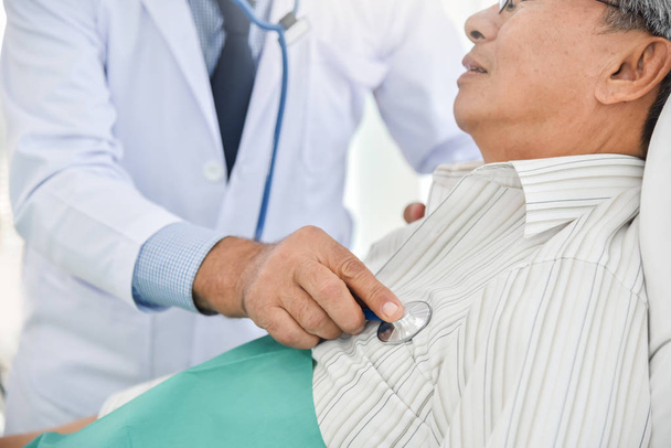 Doctor is examining An Asian senior patient. - Photo, image