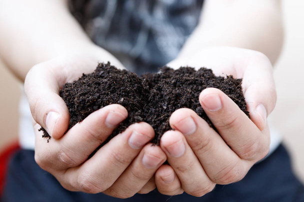 Man farmer holding soil. Earth day and ecology concept - Photo, Image