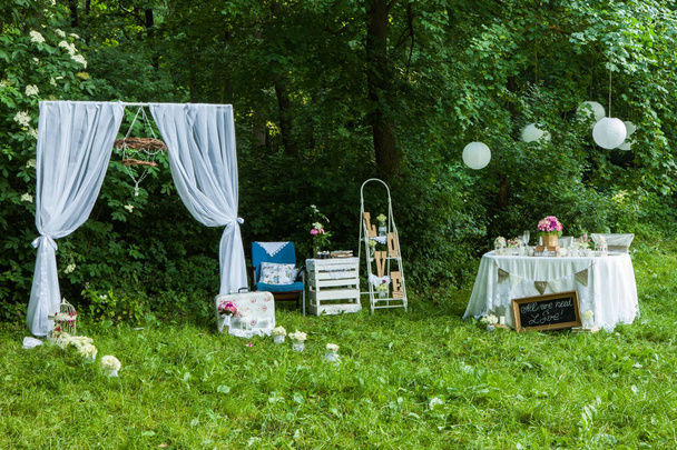 Wedding decoration in forest. Rustic wedding ceremony in forest. Vintage decoration in forest. - Fotó, kép