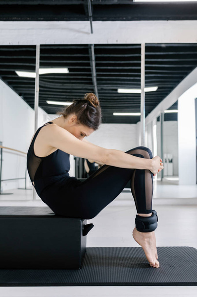A Woman Doing Reformer Pilates Exercise - Fotoğraf, Görsel