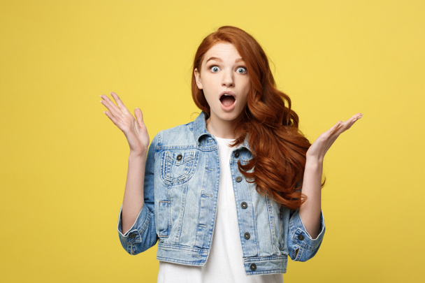 Close up Portrait amaze young beautiful attractive redhair girl shocking with something. Isolated on Bright Yellow Background. Copy space. - Zdjęcie, obraz