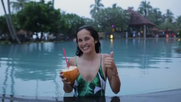 girl drinks cocktail in the pool - Кадри, відео