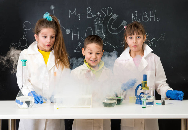three excited children after chemical experiment - Foto, Imagem