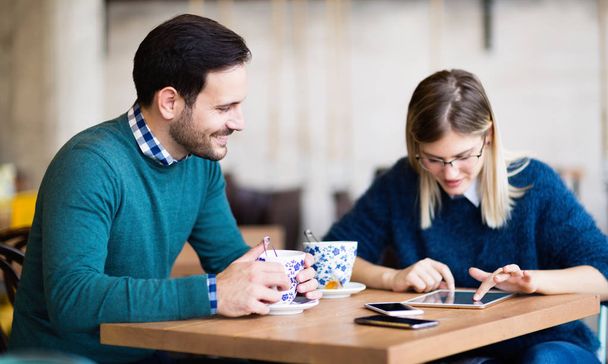 Young attractive couple on date together in coffee shop - Foto, Bild