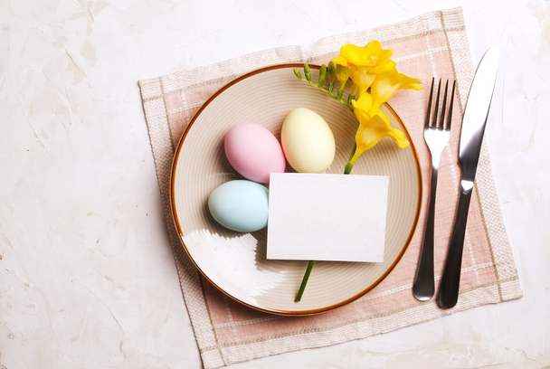 Easter laying table appointments, table setting options. Silverware, tableware items with festive decoration. Fork, knife and flowers. Happy easter holiday. - 写真・画像