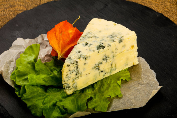 Modrý sýr se salátovými listy na dřevěném pozadí - Fotografie, Obrázek