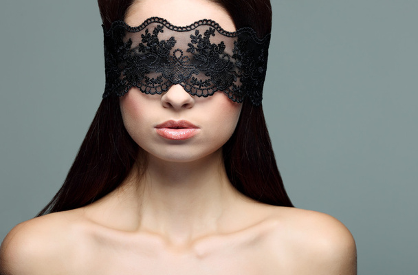 Portrait elegant sexual brunette woman is in a black lace mask - Zdjęcie, obraz