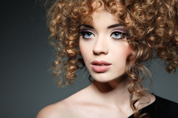 Young beautiful woman with long curly hairs - Valokuva, kuva