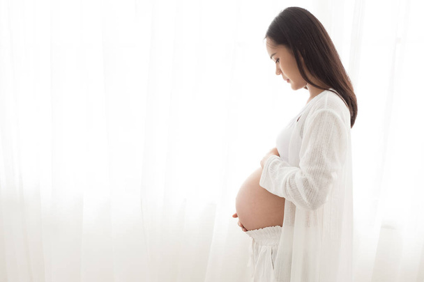 zwangere vrouw touch haar buik - Foto, afbeelding