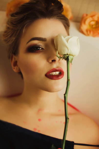 Glamor portrait of luxury blonde model holding white rose near h - Фото, изображение