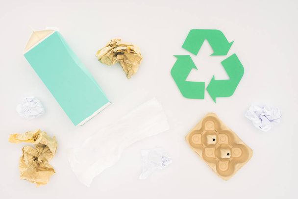 top view of various paper trash with recycle sign on white - Foto, Imagem