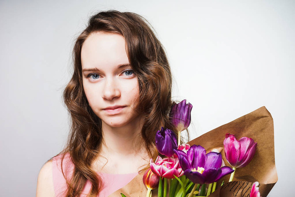 chic young blue-eyed girl holding a bouquet of fragrant flowers, celebrating Mother's Day - Фото, зображення