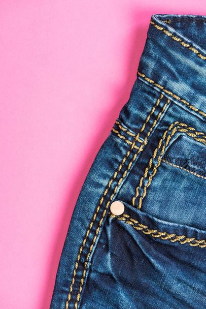 Jeans trousers on pink, flat lay - Photo, Image