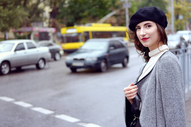 Woman walking city street in autumn looking relaxed - Фото, изображение