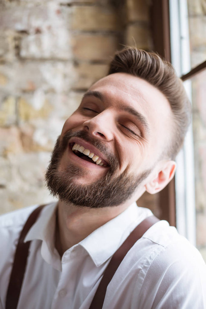 Happy portrait of smiling handsome bearded man in white shirt with very good mood. - Zdjęcie, obraz