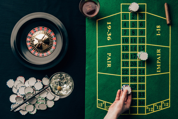Woman placing a bet on table with roulette - Photo, Image