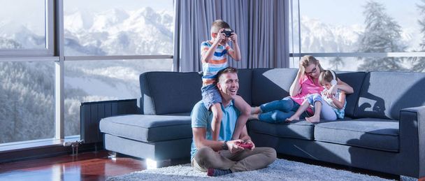 Happy family. Father, mother and children playing a video game Father and son playing video games together on the floor - Foto, Imagen