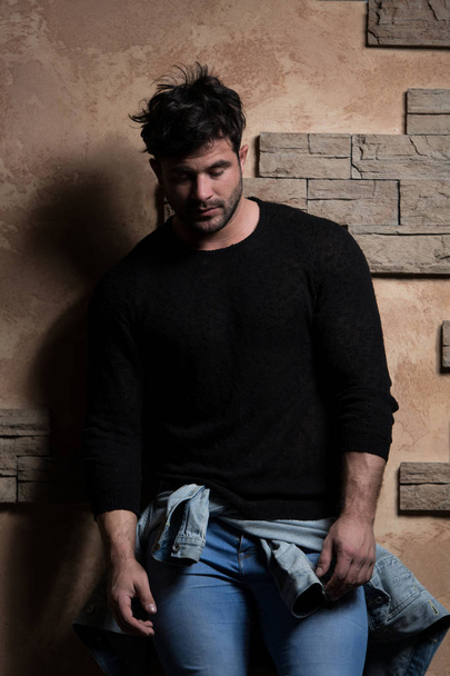 Handsome Man Leaning Against a Brick Wall - Foto, Bild