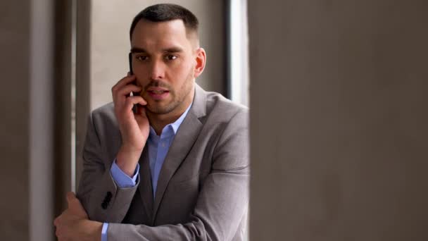 businessman calling on smartphone at office - Felvétel, videó