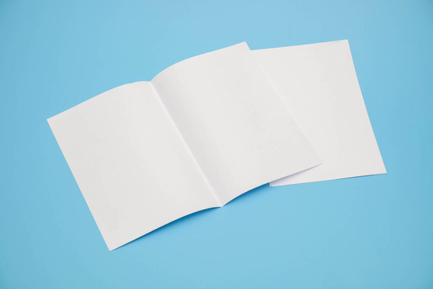 template fold white paper on blue background - 写真・画像