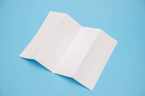 template fold white paper on blue background - Foto, afbeelding