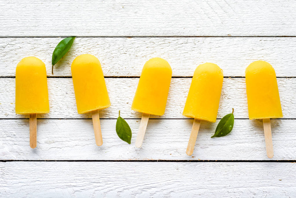 Refreshing popsicles with orange juice, natural ice lollies, flat lay, top view - Valokuva, kuva