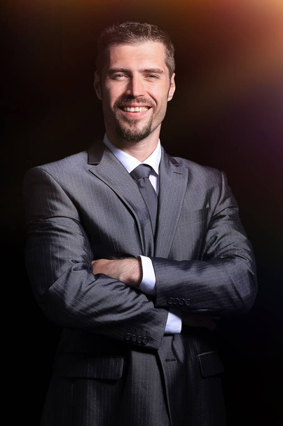 Close  up portrait of a business man on black background - Foto, Imagen