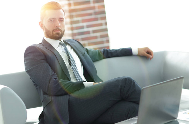 Portrait of a successful businessman sitting in the office lobby - Fotografie, Obrázek