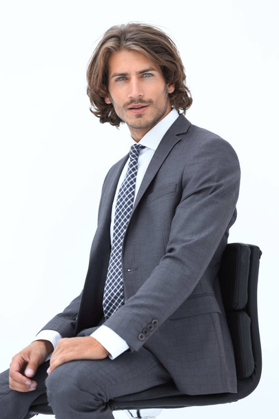 Inviting business man sitting on chair with relaxed attitude - 写真・画像