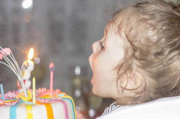 Portrait of joyful little girl with cake at birthday party . Holidays concept - Foto, Imagem