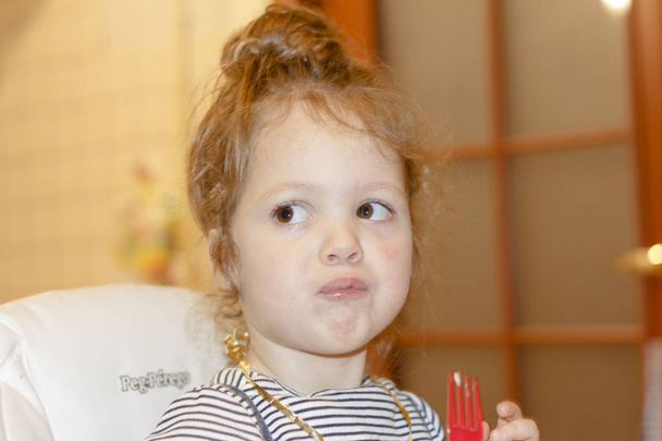 Portrait of joyful little girl with cake at birthday party . Holidays concept - Φωτογραφία, εικόνα