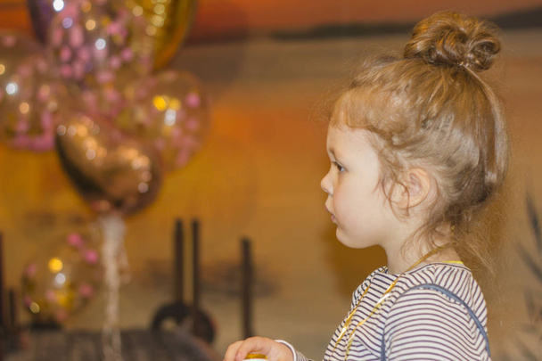Portrait of joyful little girl with cake at birthday party . Holidays concept - Foto, immagini
