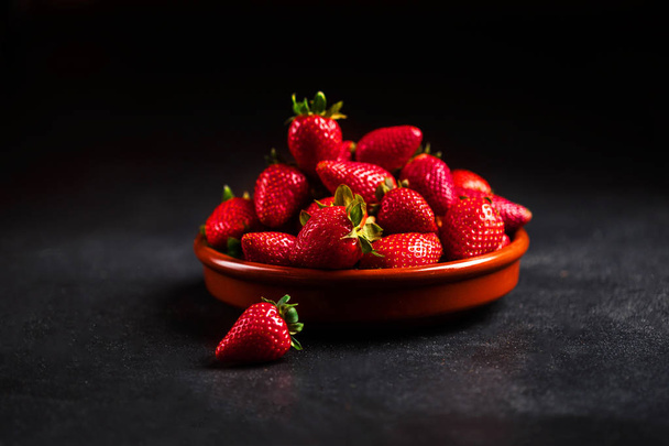 Heap of Red strawberries on plate - 写真・画像