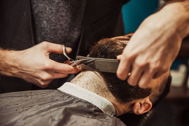 Professional Master hairdresser cuts client beard. - Фото, зображення