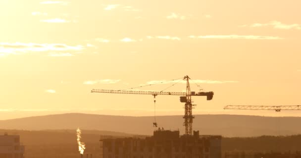γερανός πύργων στο εργοτάξιο κατά ηλιοβασίλεμα ουρανό. Αικατερινούπολη, Ρωσική Ομοσπονδία. Βίντεο. UltraHD (4Κ) - Πλάνα, βίντεο