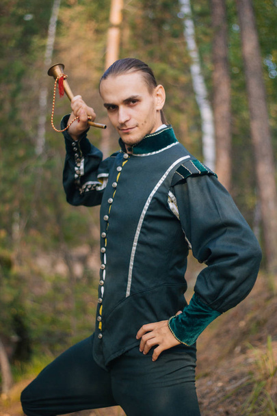 Sexy guy in the woods. In beautiful, old clothes of green color. A medieval . Fantasy.  - Foto, imagen