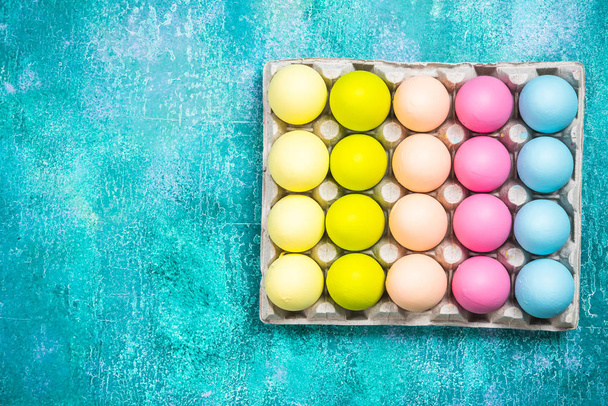 Colorful painted eggs for Easter on vibrant background. Flat lay - Photo, Image