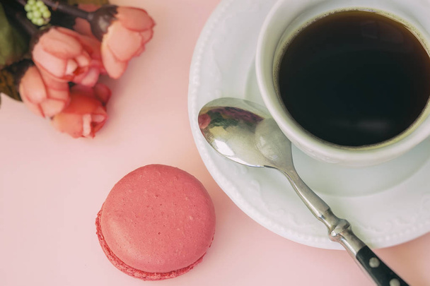 Pink macaron, macaroon and cup of coffee, spring flowers, tender pastel background. Romantic morning Dessert, gift, present for beloved - Фото, изображение