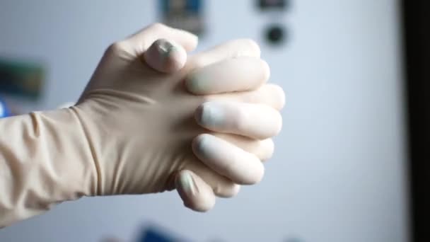 Close-up shows the doctors hands. He puts on his hands gloves. - Filmagem, Vídeo