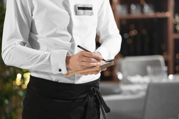 Close up of waiter taking order in restaurant - Valokuva, kuva
