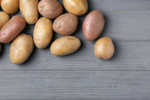 Fresh raw potatoes on wooden table - Foto, Bild