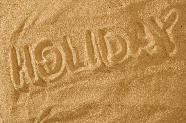 Word Holiday. Summer in the sand symbol sign. - Foto, Bild