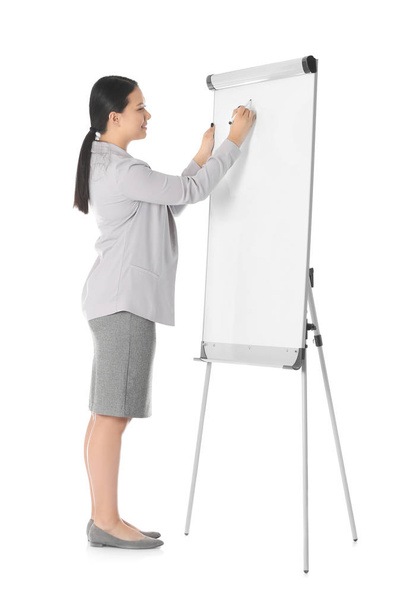 Business trainer giving presentation on flip chart board against white background - Foto, afbeelding