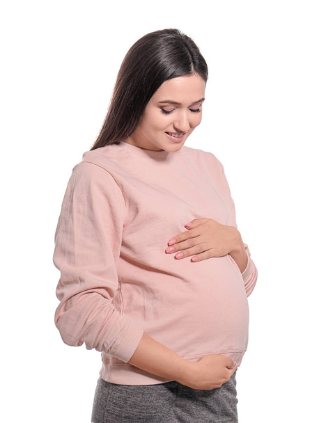 Young pregnant woman in casual clothes on white background - Foto, Imagen