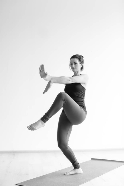 Sporty woman practicing yoga indoors - Foto, Bild