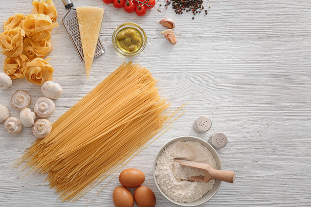Uncooked pasta and products on light background - Foto, immagini